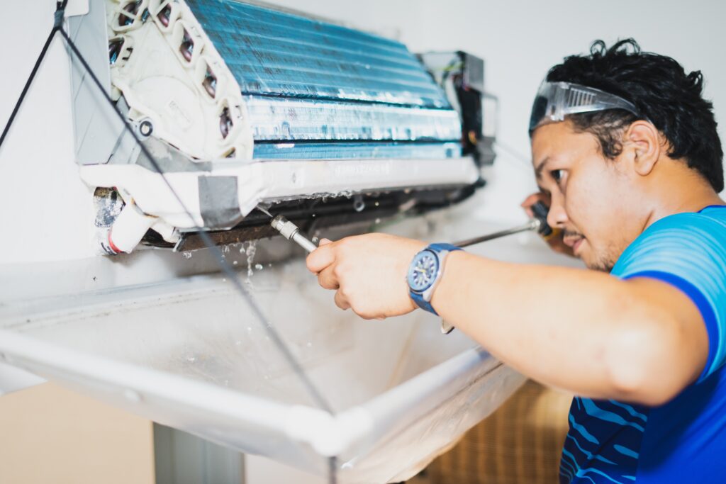 Spraying water while cleaning air conditioner indoors